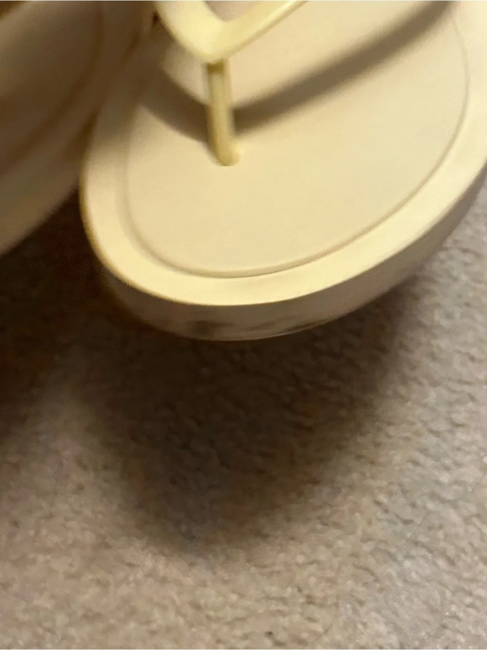 TORY BURCH KIRA padded flip flops in light yellow.